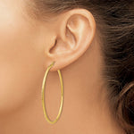 Load image into Gallery viewer, 14K Yellow Gold Diamond-cut 2mm Round Tube Hoop Earrings 55mm length